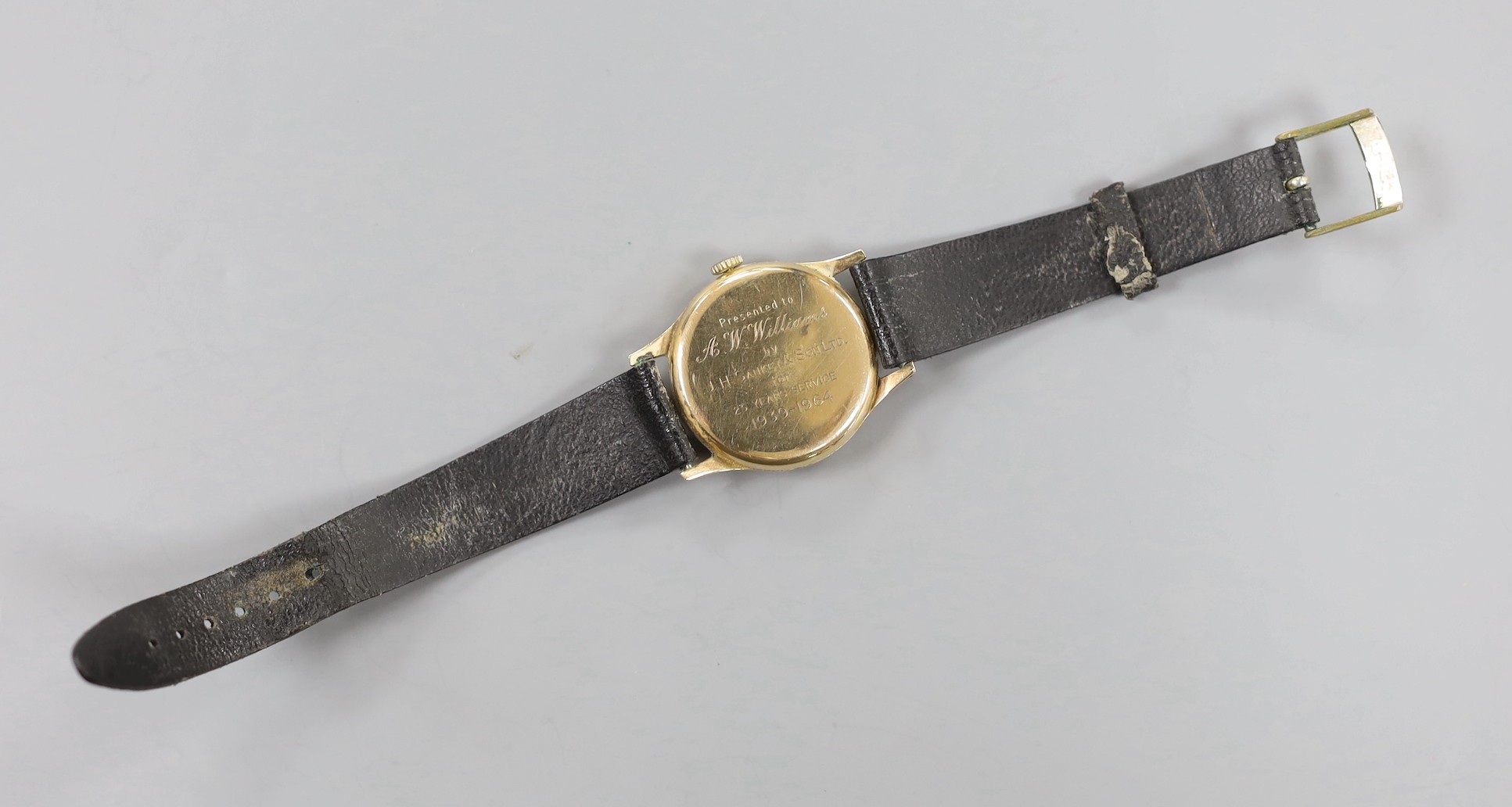 A gentleman's 1960's 9ct gold Longines manual wind wrist watch, with case back inscription, case diameter 33mm, on associated leather strap, gross weight 36.5 grams.
